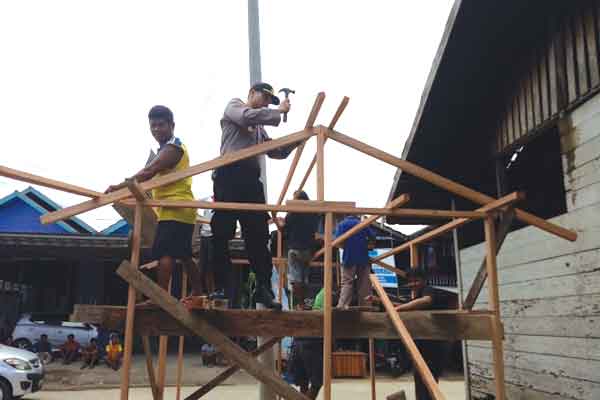 Foto: Kapolsek Melak AKP.Djoko Purwanto Ikut Membentu Warga Mendirikan Poskamling