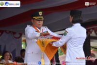 Foto Caption : Bupati Mahulu Bonifasius Belawan Geh Saat Menyerahkan Sang Saka Merah Putih untuk dikibarkan pada Upacara Peringatan HUT ke-80 RI.