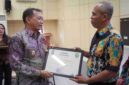 Foto Wakil Bupati Kutai Barat, H.Nanang Adriani Saat Menyerahkan Piagam Penghargaan Kepada Bahrin Selaku Kasi Pendidikan dan Kesehatan Kecamatan Penyinggahan Atas Prestasi Percepatan Penurunan Stunting.